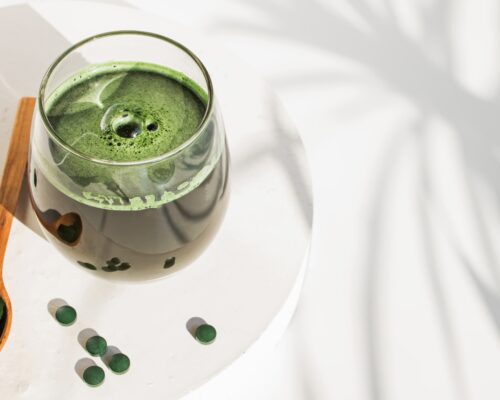 Spirulina juice and tablets supplement on a table